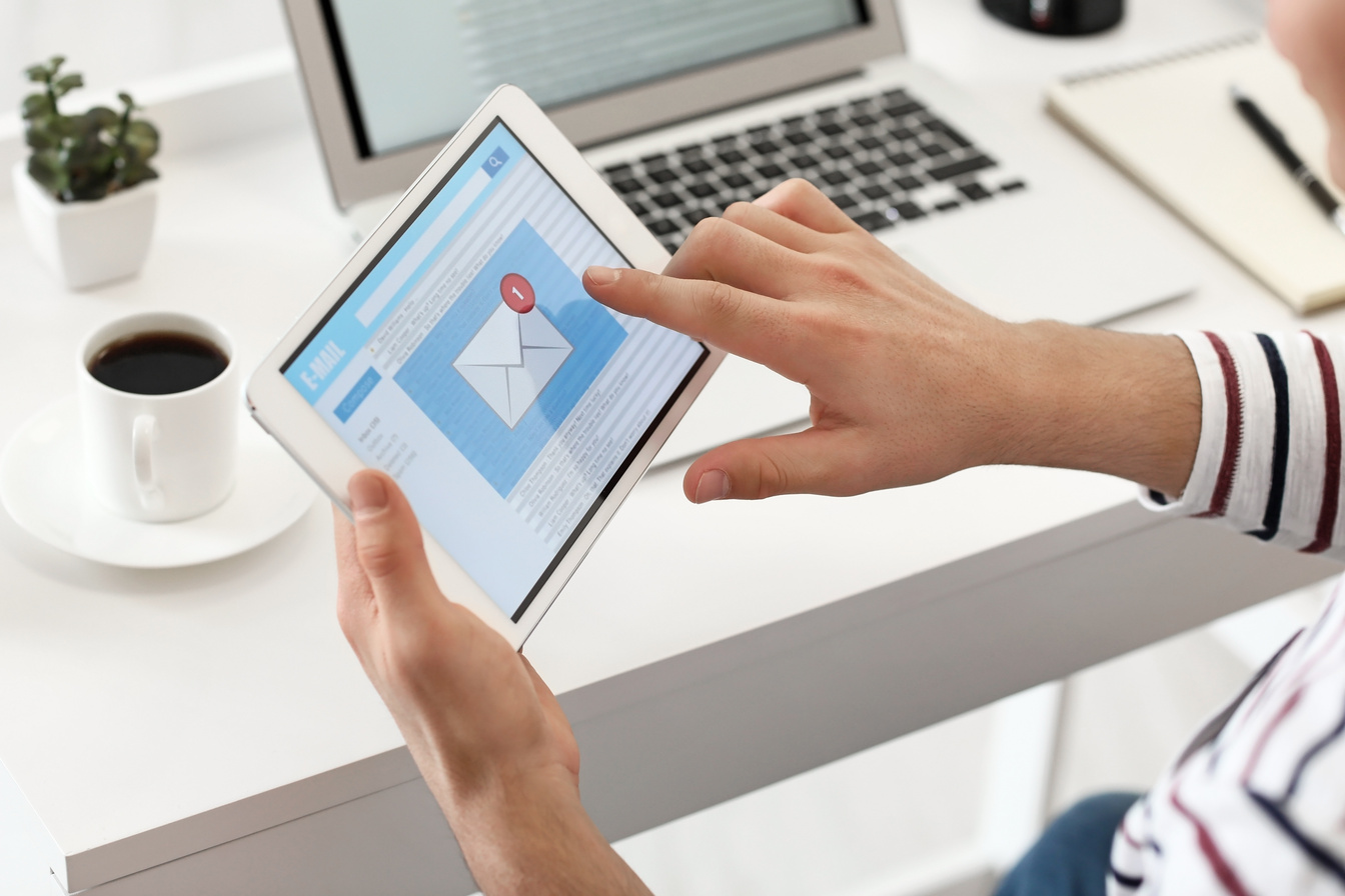 Young Man Receives an E-mail on His Tablet